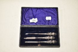 An Edwardian silver manicure set in blue fabric lined box, one item missing.