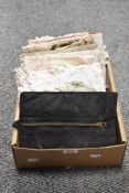 A selection of vintage table linen, including embroidered items and a leather collar case.