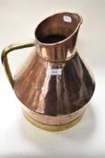 A large late 19th century grain measure, having copper body and brass handle and band to base.