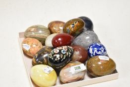 A collection of natural stone and painted wood eggs, including marble and onyx.