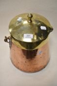 A vintage copper and brass lidded churn, having brass handle and feet.