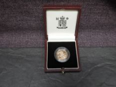 A United Kingdom Royal Mint 1999 Queen Elizabeth II Proof Gold in capsule and in case