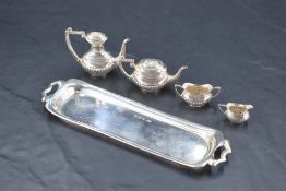 A matched miniature five-piece silver teaset, of half gadrooned oval baluster form, comprising