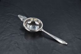 An Edward VIII silver tea strainer, of traditional design with Art Deco motifs, marks for