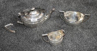 A three piece silver tea set of tapered oval form having pressed decoration to rim, Chester 1921,