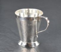 A 1930's silver christening tankard, of tapering cylindrical form with shaped handle and short