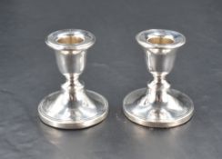 A pair of George V silver squat candlesticks, with moulded detail, marks for Birmingham 1921,