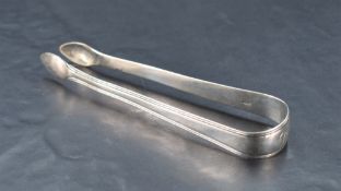 A pair of William IV silver sugar tongs, with reeded edge detail and engraved initials, marks for