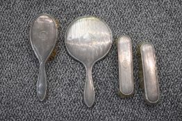 A four piece silver dressing table set having engine turned stripe decoration and bearing initial '