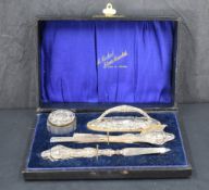 A George V silver mounted four piece manicure set, marks for Birmingham 1917, maker G & C Ltd, all