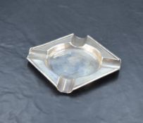 A 20th century silver ashtray, of canted square form with moulded rim and rests, engraved to