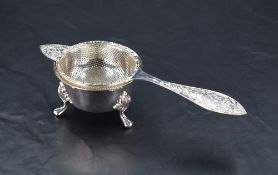 A Queen Elizabeth II silver tea strainer, of dished circular form with fine perforations throughout,