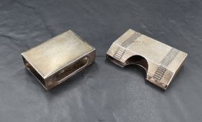 An early 20th century white metal match book holder, engine-turned decoration and marked 'silver' to