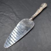 A Queen Elizabeth II silver mounted cake slice, marks for Sheffield 1976, maker HB, cased, sold