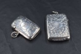 Two Edwardian silver vesta cases, of traditional design engraved with foliate decoration, marks