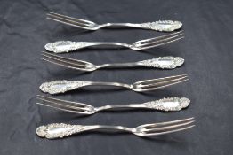 A set of six American sterling silver dessert forks, each having three slender tines, the