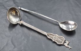 An early 20th century Russian white metal spoon, having an oval bowl with engraved reverse, the