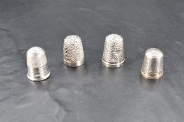 A group of four silver thimbles, Birmingham 1900, 1906, Chester 1893 & Sheffield 1979, 12.7grams