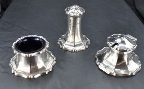 An early 20th century silver three-piece condiment set, of spreading stylised petal design with