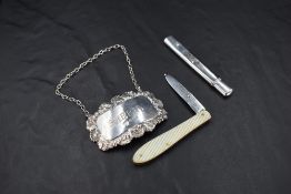 A Queen Elizabeth II silver sherry label, of traditional design with embossed scallop and