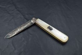 An Edwardian silver bladed and mother-of-pearl mounted pocket knife, the blade with foliate scroll