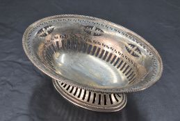 A George V silver dish, of oval form pierced with repeating designs, and raised on a spreading