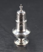 A George V silver pepperette, of urn form with pierced finial topped pull-off cover, marks for
