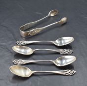A group of four Edwardian silver teaspoons and sugar tongs, having pierced and entwined stem