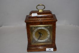 A modern John Walker Elliott bracket clock having a Walnut burr veneer case.