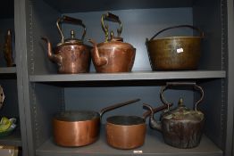 A selection of vintage kitchen stove items including three copper kettles, a jam pan and two