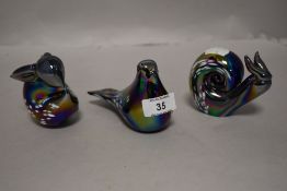 Three modern iridescent glass paper weights in the form of a rabbit, bird and snail.