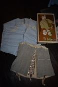 An early 20th century corset in grey and a 1940s camisole in powder blue.