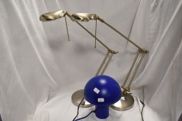 A pair of modern adjustable desk top brushed steel lamps and a glass mushroom lamp.