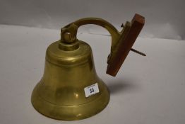 A brass door bell with bracket, missing its ringer.