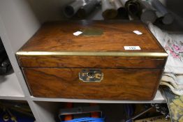 A Victorian writing slope having mahogany case with brass banding and a fitted interior.