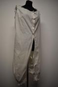 A scarce all in one Victorian cotton undergarment with lace to cuffs, arm openings and neckline.