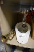 An ideal bed and douche slipper with a brass horn and clear glass oil burning lamp.
