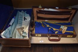 Two early 20th century Masonic cases containing regalia including medals, tabards and ephemera.