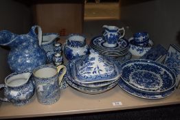A mixed selection of blue and white wares including jugs, mugs, plates dishes and some Spode