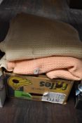 Four vintage cellular blankets, two cream and two pink.
