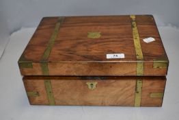 A Victorian Mahogany writing slope having fitted interior with brass banding.