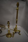 A fine early 20th century adjustable brass reading lamp having tripod lions feet base with a similar