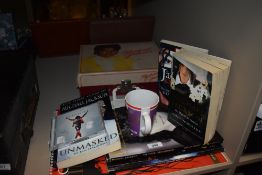 A selection of Michael Jackson collectables including a record player, biographies and calendar