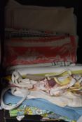 A miscellany of textiles to include mid century aprons, A pyjama case, brightly printed mid