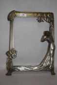 An Art Nouveau picture or mirror frame in an Archibald Knox Liberty style with female figure and