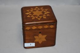 An Edwardian Mahogany tea caddy with inlaid geometric marquetry