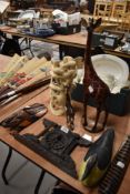 Two hand painted giraffe figures with a similar wall sconce a Middle Eastern mask plaque and a