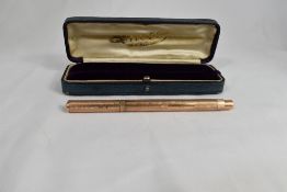 An Onoto 9ct gold pump fill fountain pen with engine turned decoration, clipless cap. Marked D L R