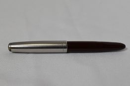 A Parker 51 demi button fill fountain pen in burgundy with lustraloy cap. In good condition