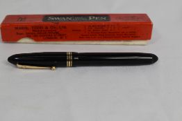 A boxed Mabie Todd & Co Swan leverless 4261 twist fill fountain pen in black with one broad and
